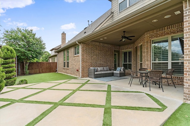 view of patio featuring a fenced backyard, ceiling fan, and an outdoor living space