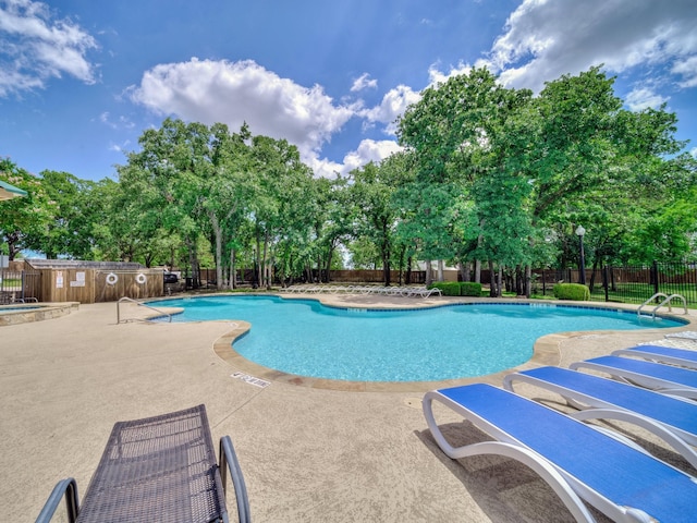 2500 Westheimer Rd, Denton, TX 76210 - community pool with fence, a patio area, and view of wooded area