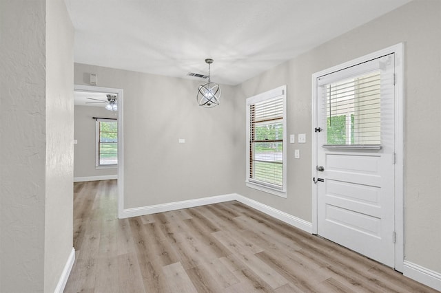 501 S Eddy Ave, Denison, TX 75020 - unfurnished dining area with light wood-style floors and a ceiling fan