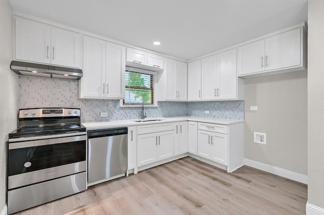 501 S Eddy Ave, Denison, TX 75020 - kitchen with stainless steel appliances, range hood, light wood-type flooring, white cabinetry, and recessed lighting