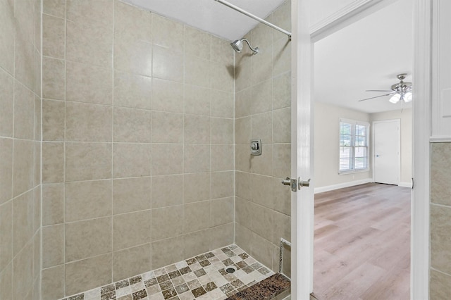 501 S Eddy Ave, Denison, TX 75020 - bathroom with a tile shower, a ceiling fan, and wood finished floors