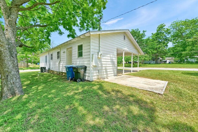 501 S Eddy Ave, Denison, TX 75020 - view of home's exterior with a lawn and an attached carport