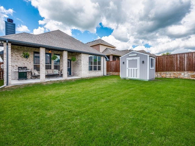 11724 Pistachio Trl, Fort Worth, TX 76108 - rear view of property with a storage unit, roof with shingles, a patio, an outdoor structure, and brick siding