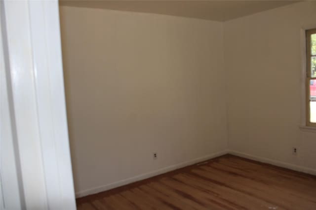 114 Wilmington Ave, Waxahachie, TX 75165 - spare room featuring wood finished floors and baseboards