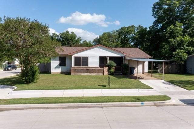 114 Wilmington Ave, Waxahachie, TX 75165 - ranch-style home featuring concrete driveway, a front lawn, and a carport