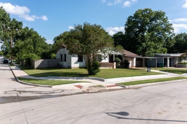 114 Wilmington Ave, Waxahachie, TX 75165 - view of property hidden behind natural elements with a front lawn and concrete driveway