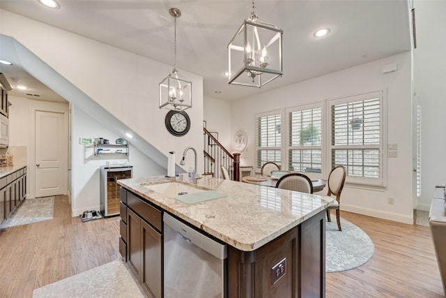 7320 San Saba Dr, Mckinney, TX 75070 - kitchen with stainless steel dishwasher, beverage cooler, light wood-type flooring, dark brown cabinetry, and recessed lighting