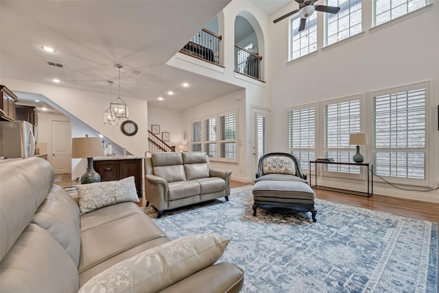 7320 San Saba Dr, Mckinney, TX 75070 - living room featuring stairs, wood finished floors, recessed lighting, a ceiling fan, and a high ceiling
