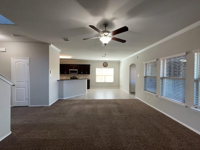 3000 Buckthorn St, Forney, TX 75126 - unfurnished living room with light carpet, ornamental molding, a ceiling fan, baseboards, and arched walkways