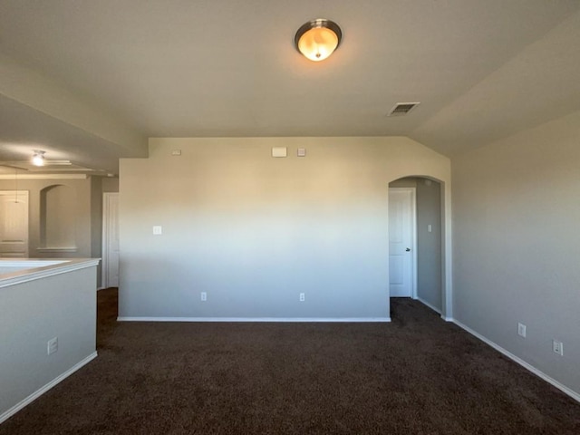 3000 Buckthorn St, Forney, TX 75126 - spare room featuring arched walkways, dark carpet, baseboards, and lofted ceiling