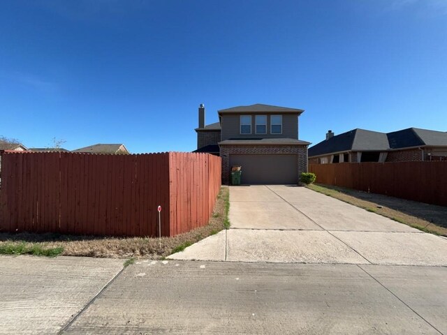 3000 Buckthorn St, Forney, TX 75126 - view of front of house featuring fence, concrete driveway, a garage, and brick siding