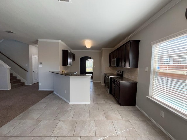 3000 Buckthorn St, Forney, TX 75126 - kitchen featuring stainless steel appliances, arched walkways, dark brown cabinets, plenty of natural light, and ornamental molding