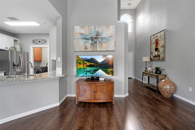3421 Paisano Trl, Plano, TX 75093 - bar with stainless steel fridge with ice dispenser, dark wood finished floors, a sink, baseboards, and decorative light fixtures
