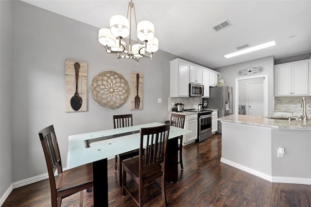 3421 Paisano Trl, Plano, TX 75093 - dining room featuring dark wood-style floors, a chandelier, and baseboards