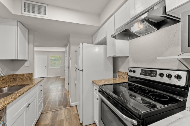 531 Norwood Cir E, Arlington, TX 76013 - kitchen featuring electric range, under cabinet range hood, white cabinetry, light wood-style floors, and light stone counters