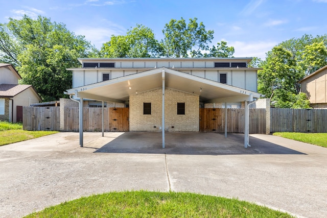 531 Norwood Cir E, Arlington, TX 76013 - view of front of property featuring driveway, brick siding, fence, a carport, and a gate