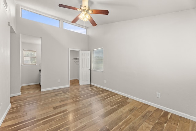 531 Norwood Cir E, Arlington, TX 76013 - unfurnished bedroom with wood finished floors, baseboards, a spacious closet, a towering ceiling, and a closet