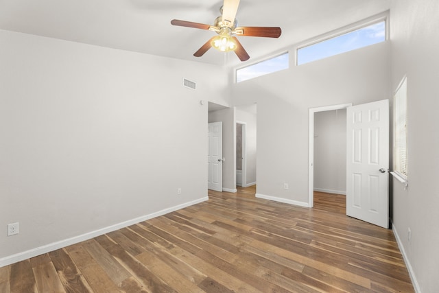 531 Norwood Cir E, Arlington, TX 76013 - unfurnished bedroom with high vaulted ceiling, hardwood / wood-style floors, a spacious closet, baseboards, and ceiling fan