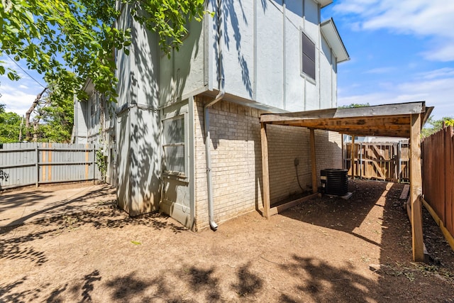 531 Norwood Cir E, Arlington, TX 76013 - view of side of property featuring brick siding, a fenced backyard, stucco siding, and central air condition unit