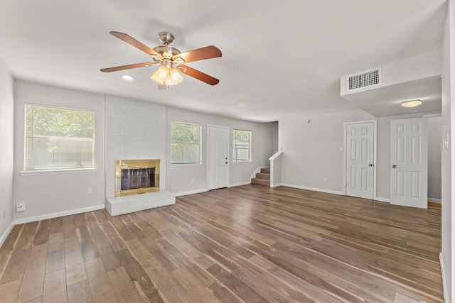 531 Norwood Cir E, Arlington, TX 76013 - unfurnished living room with wood finished floors, plenty of natural light, and stairs