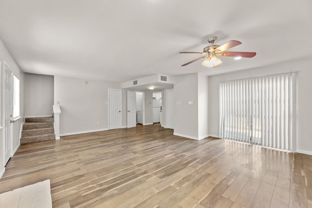 531 Norwood Cir E, Arlington, TX 76013 - unfurnished living room with ceiling fan, light wood-style flooring, stairway, and baseboards