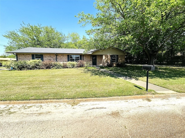 202 Wanda Dr, Winnsboro, TX 75494 - view of front of house with a front yard and brick siding