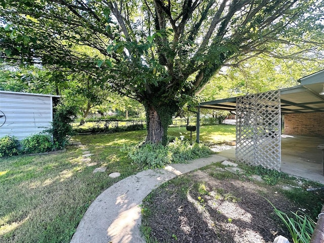 202 Wanda Dr, Winnsboro, TX 75494 - view of green lawn featuring a carport