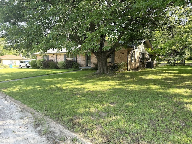 202 Wanda Dr, Winnsboro, TX 75494 - view of front of home with a front yard and brick siding