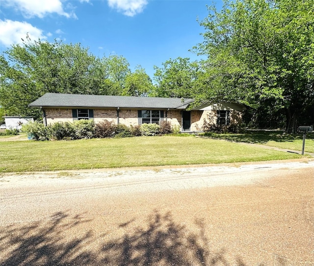 202 Wanda Dr, Winnsboro, TX 75494 - view of front facade with a front lawn and brick siding