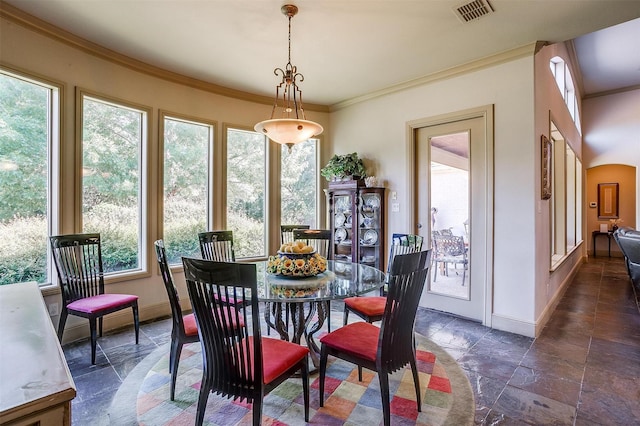 6700 Lions Gate Ct, Arlington, TX 76001 - dining area with stone tile flooring, baseboards, plenty of natural light, and crown molding