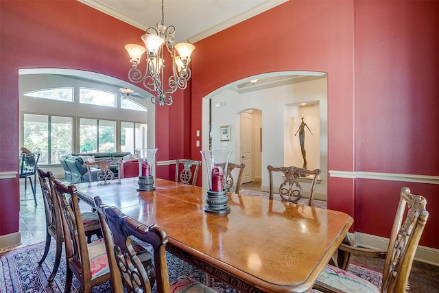 6700 Lions Gate Ct, Arlington, TX 76001 - dining space with arched walkways, crown molding, baseboards, and a chandelier