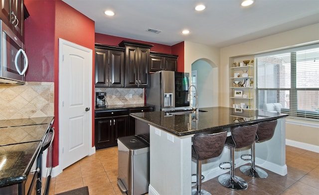 9521 Cholla Cactus Trl, Fort Worth, TX 76177 - kitchen featuring a sink, appliances with stainless steel finishes, arched walkways, healthy amount of natural light, and recessed lighting