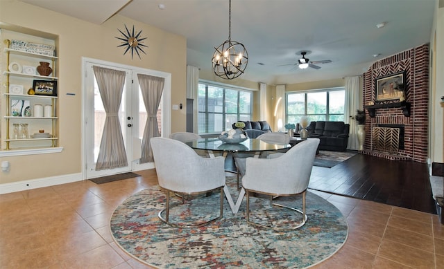 9521 Cholla Cactus Trl, Fort Worth, TX 76177 - dining area with tile patterned floors, ceiling fan, a fireplace, and baseboards