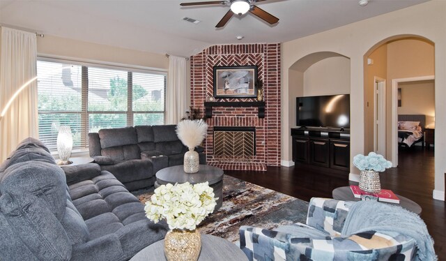 9521 Cholla Cactus Trl, Fort Worth, TX 76177 - living room featuring ceiling fan, wood finished floors, lofted ceiling, arched walkways, and a brick fireplace