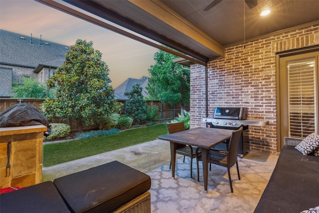 view of patio featuring a grill, outdoor dining area, a fenced backyard, and a ceiling fan