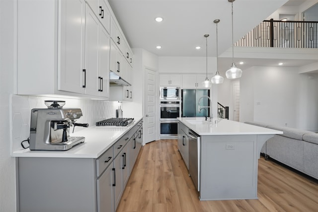 4008 Prickly Pear Ave, Aubrey, TX 76227 - kitchen with built in appliances, open floor plan, gray cabinets, light wood finished floors, and light countertops