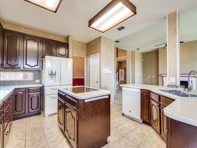 2540 Briardale Dr, Carrollton, TX 75006 - kitchen with white appliances, light tile patterned floors, a kitchen island, a sink, and tasteful backsplash