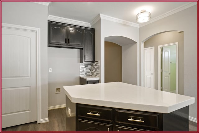 5005 Odeum Ct, Fort Worth, TX 76244 - kitchen with ornamental molding, dark wood-type flooring, decorative backsplash, light countertops, and dark cabinetry