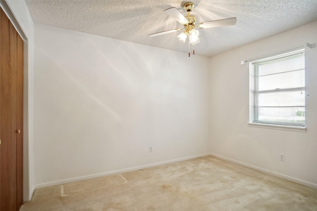 1508 Raborn Dr, Bowie, TX 76230 - empty room featuring a textured ceiling, light colored carpet, baseboards, and a ceiling fan