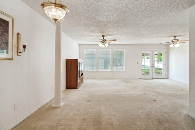 1508 Raborn Dr, Bowie, TX 76230 - unfurnished living room with a ceiling fan, carpet flooring, a textured ceiling, french doors, and baseboards