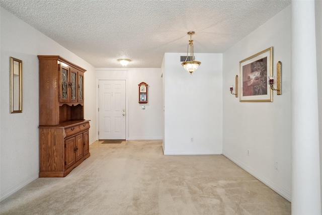 1508 Raborn Dr, Bowie, TX 76230 - unfurnished room featuring light colored carpet, a textured ceiling, and baseboards
