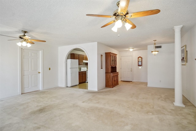 1508 Raborn Dr, Bowie, TX 76230 - unfurnished living room with a ceiling fan, light carpet, a textured ceiling, and arched walkways