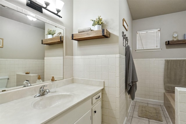 1512 Hulme St, Bowie, TX 76230 - bathroom with tile walls, tile patterned floors, vanity, a wainscoted wall, and a bathtub