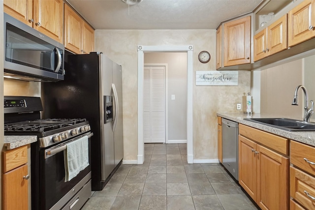 1512 Hulme St, Bowie, TX 76230 - kitchen with stainless steel appliances, a sink, light countertops, and baseboards