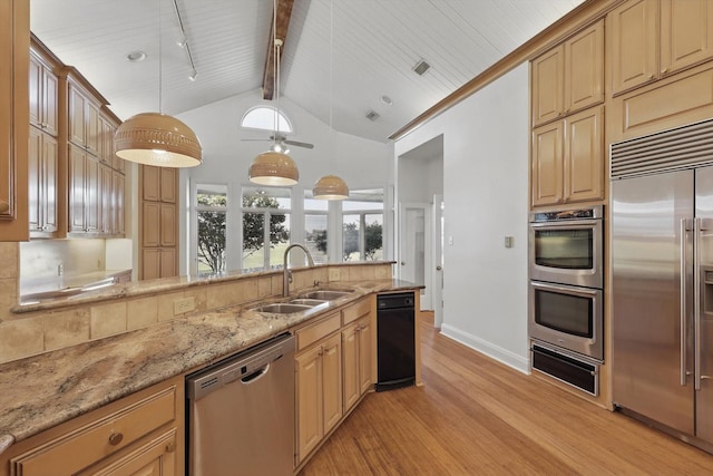 1424 Hidden Oaks Cir, Corinth, TX 76210 - kitchen with appliances with stainless steel finishes, light wood finished floors, a warming drawer, a sink, and light stone countertops