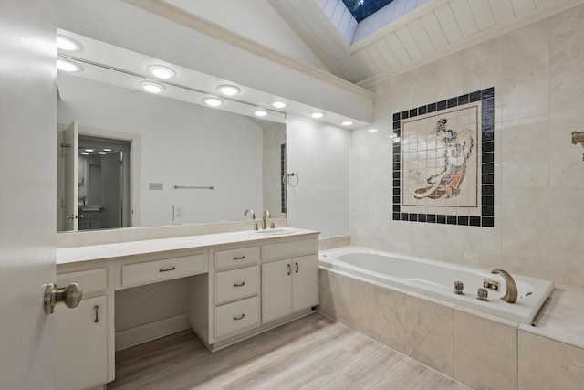 1424 Hidden Oaks Cir, Corinth, TX 76210 - full bathroom featuring a skylight, a garden tub, vanity, wood finished floors, and lofted ceiling