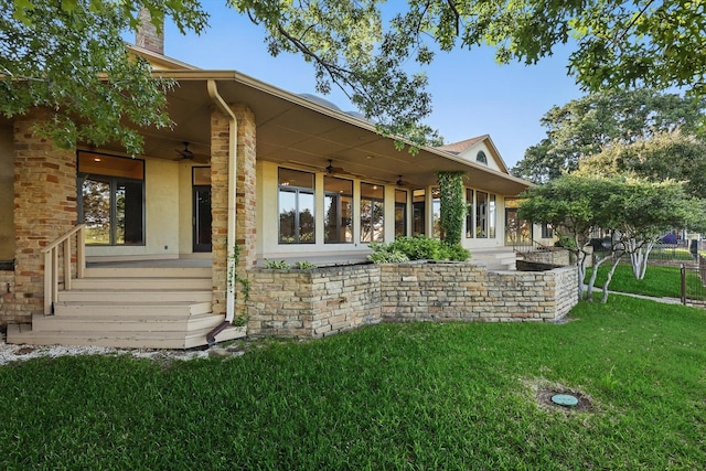 1424 Hidden Oaks Cir, Corinth, TX 76210 - back of property featuring ceiling fan, a lawn, stucco siding, a porch, and stone siding