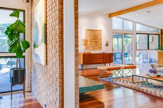 5848 Colhurst St, Dallas, TX 75230 - corridor featuring hardwood / wood-style flooring and brick wall