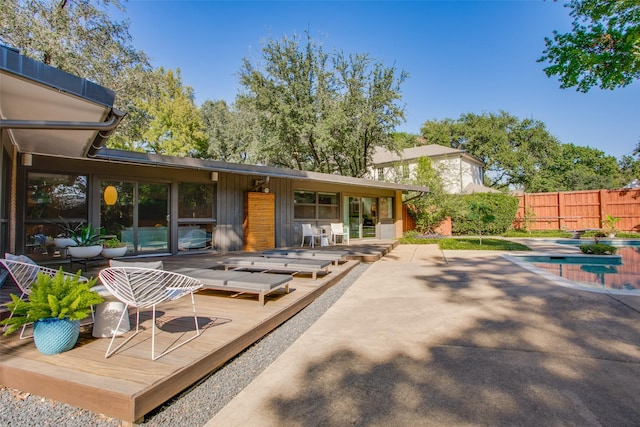 5848 Colhurst St, Dallas, TX 75230 - back of house featuring a deck, fence, and board and batten siding