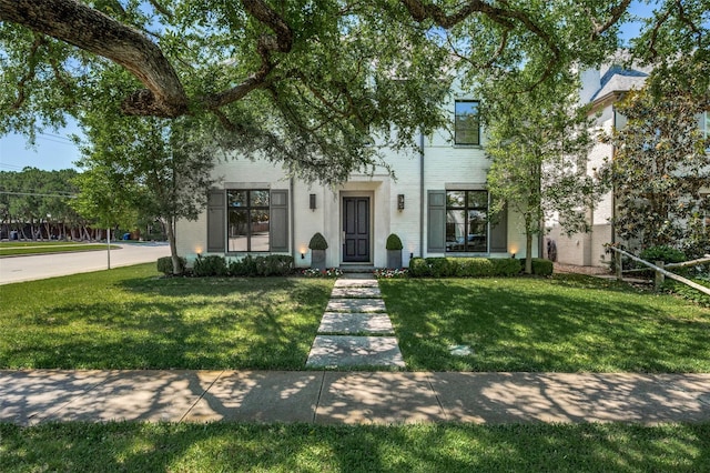 view of front of property with brick siding and a front yard